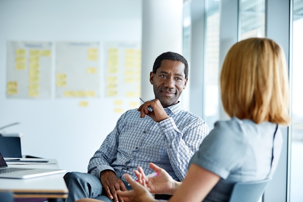 man_talking_to_woman_in_office